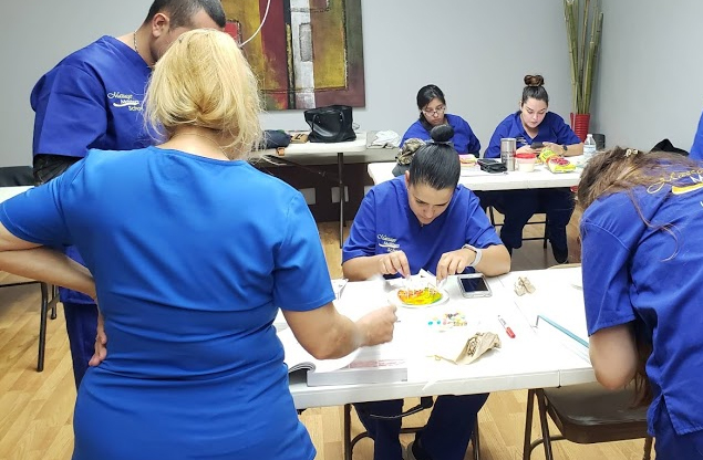 Massage therapy students learning in the classroom at Massage Masters School in Pharr, TX