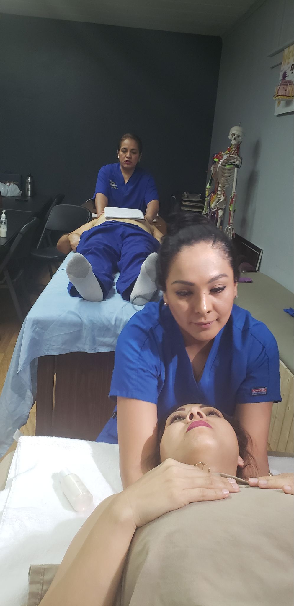 Students practicing hands-on clinic massage training at Massage Masters School in Pharr, TX